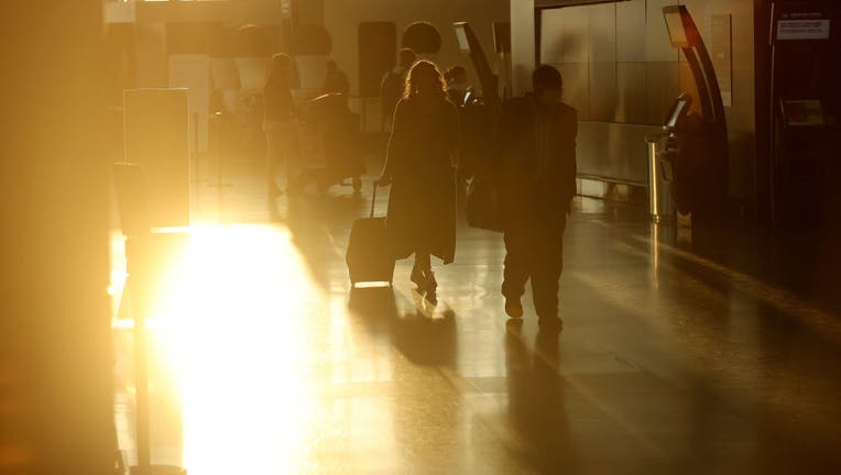 Passengers in Toronto Pearson International Airport Terminal One early in the morning, passengers that arrive early are instructed to wait at pillars 14 and 15 for their flights to be called before they go to Gate F for security and customs.