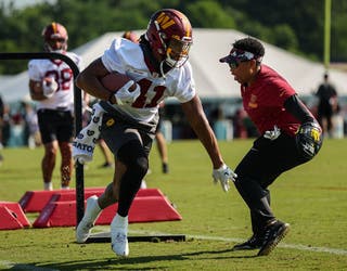 Ashburn, Virginia, USA. August 9, 2021: Washington Football Team running  back J.D. McKissic (41) runs drills with Washington Football Team  assistance running backs coach Jennifer King during the team's NFL football  training