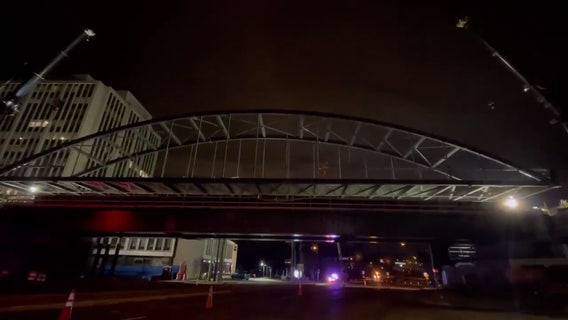 Purple Line construction crews lower arches onto bridge span in Chevy Chase