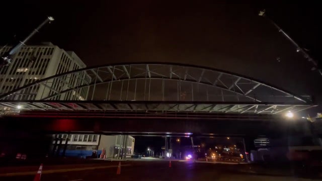 Purple Line construction crews lower arches onto bridge span in Chevy Chase