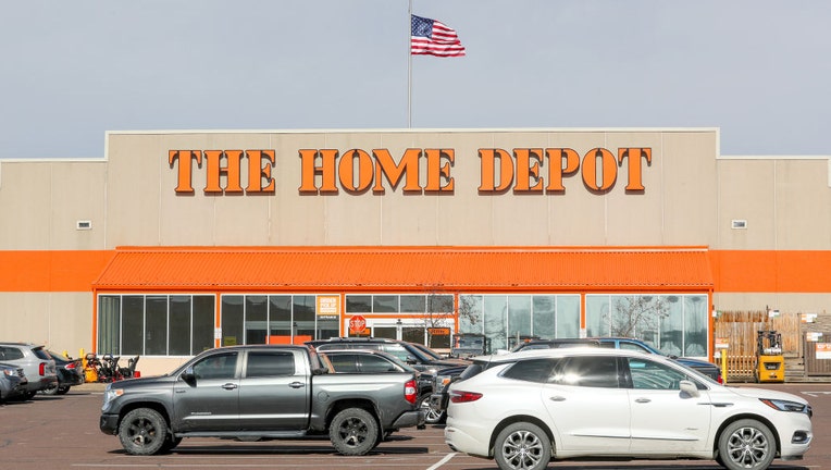 Vehicles fill the parking lot of a Home Depot store in