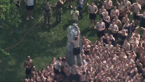Naval Academy plebes climb, cap Herndon Monument in Annapolis