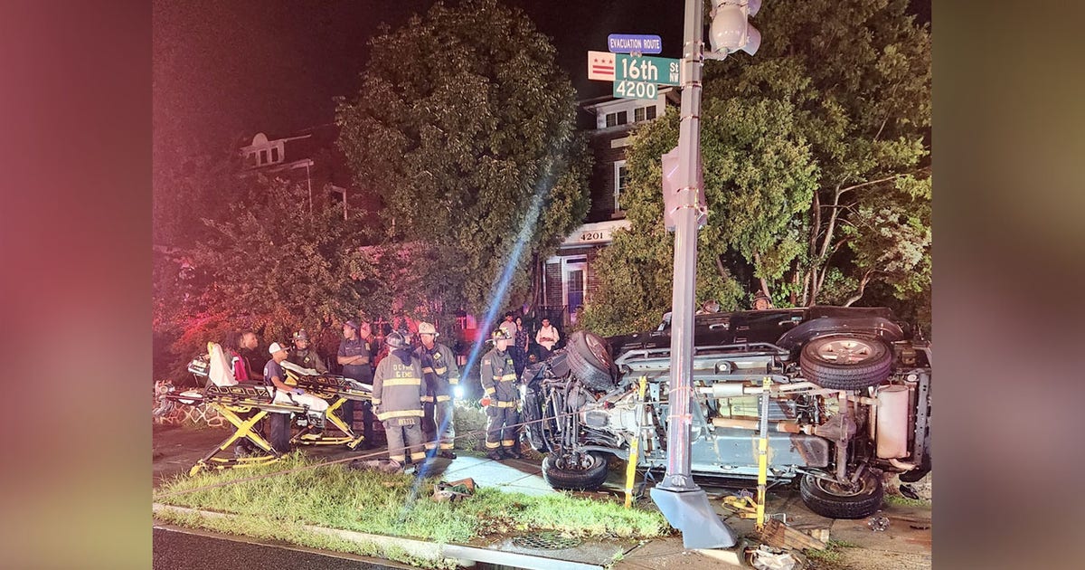 Driver trapped in vehicle that overturned after crashing into traffic ...