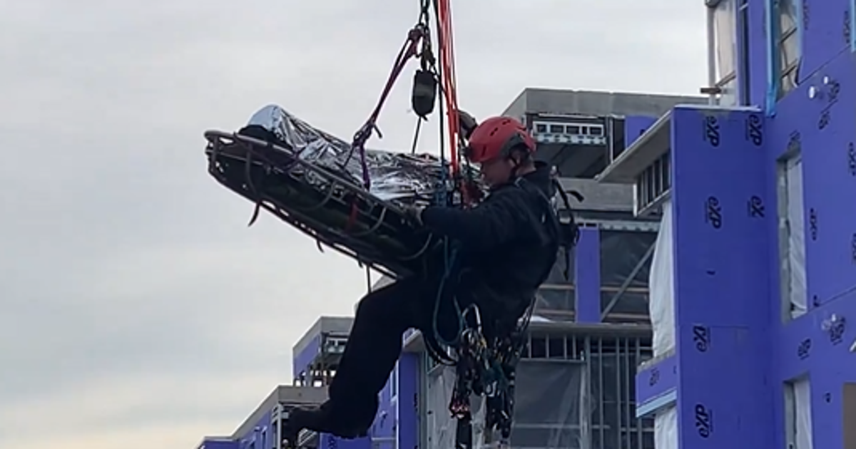 Injured DC worker rescued in crane from rooftop of a construction ...