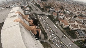 Parkour daredevil does pullups off edge of Istanbul building