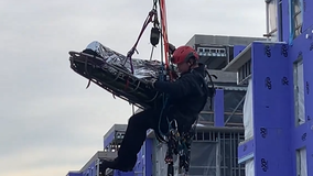 Injured DC worker rescued in crane from rooftop of a construction building