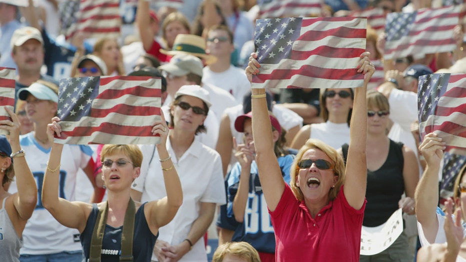 FILE - Fans cheer as Toby Keith sings his hit single