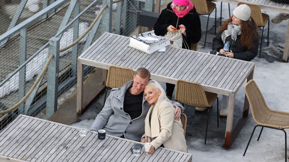 FILE - Helsinki residents spend their Sunday in early March 2024 at a café of an outdoor swimming pool. (Photo by Takimoto Marina/SOPA Images/LightRocket via Getty Images)