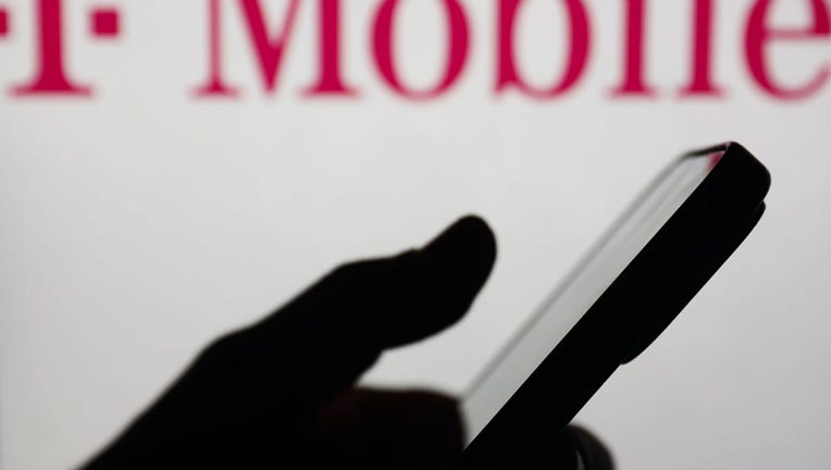 FILE - T-Mobile logo displayed on a laptop screen and a smartphone are seen in this illustration photo taken on Feb. 22, 2024. (Photo by Jakub Porzycki/NurPhoto via Getty Images)