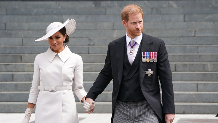 prince harry and meghan markle holding hands in formal dress