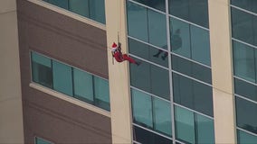 Holiday heroes rappel down Virginia children’s hospital to surprise young patients at windows