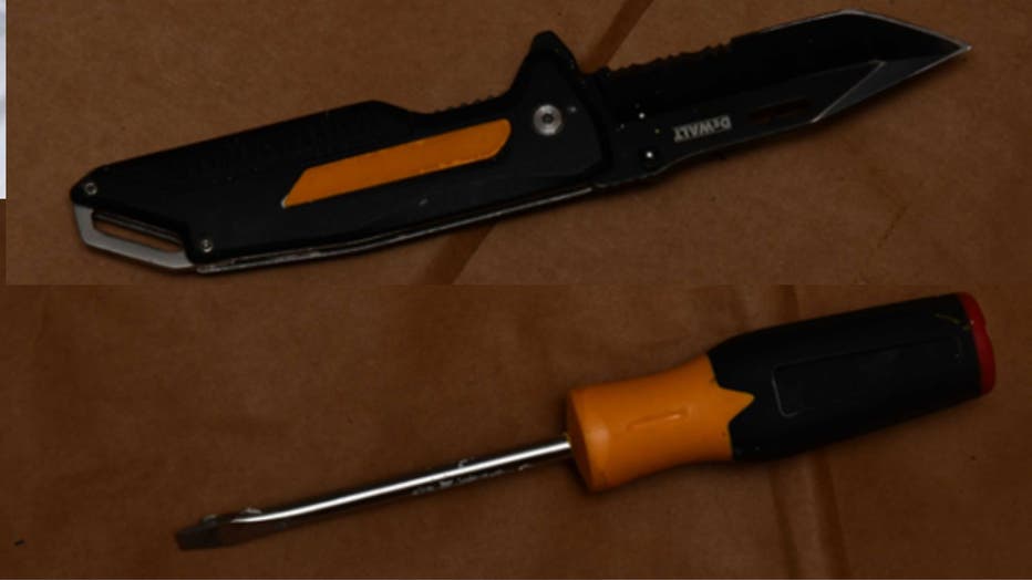 A yellow and black folding knife and a yellow and black flathead screwdriver.