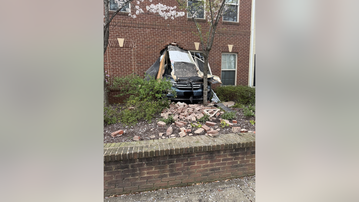 Road closed after car crashed into building in Arlington
