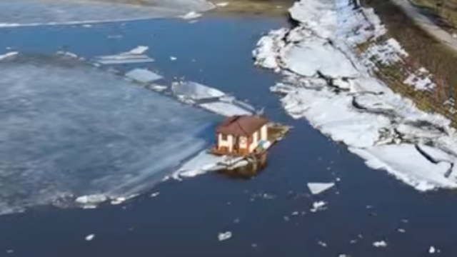 Melting ice sends tiny house drifting down river