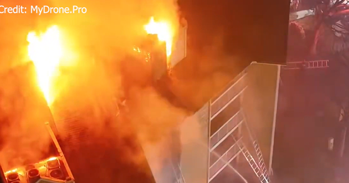 1 rescued as fire crews battle massive blaze at apartment building in ...