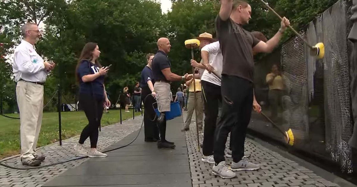 Volunteers wash Vietnam Veterans Memorial wall
