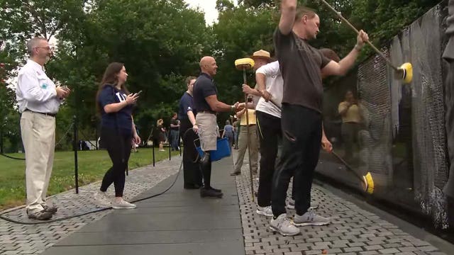 Volunteers wash Vietnam Veterans Memorial wall