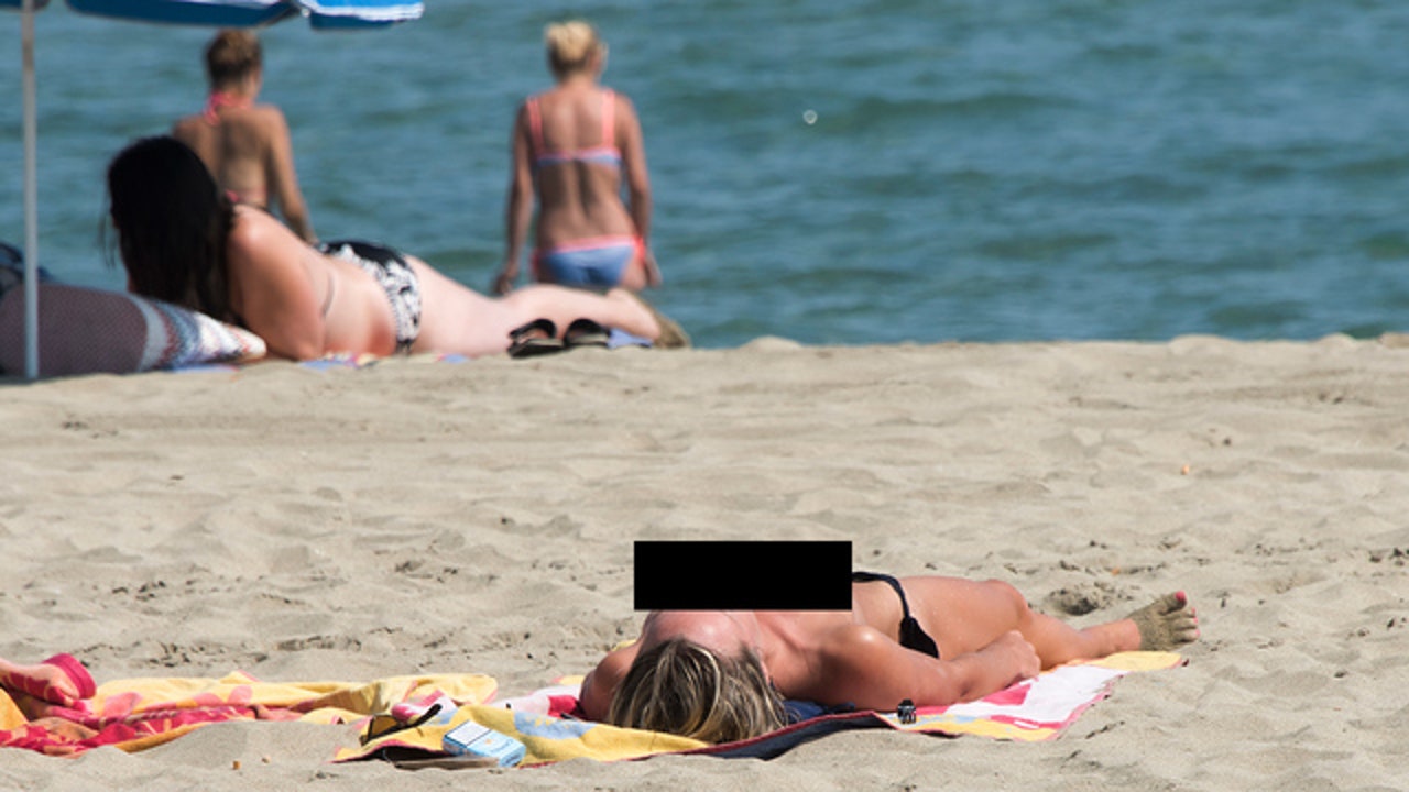 amateur beach topless sunbathing