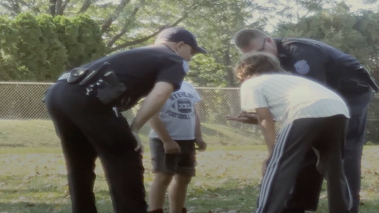 Police officers join children's pickup football game