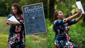 'I make mom cry': Woman poses with dissertation in 'baby' photo shoot to celebrate doctorate