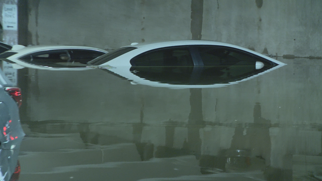 Vehicles submerged in flooded Love Field parking garages