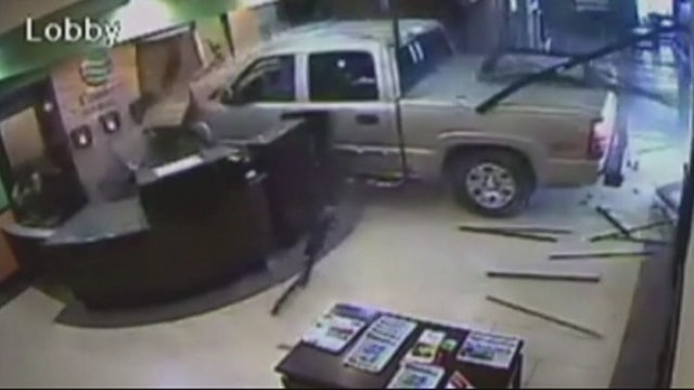 Driver slams truck into hotel lobby