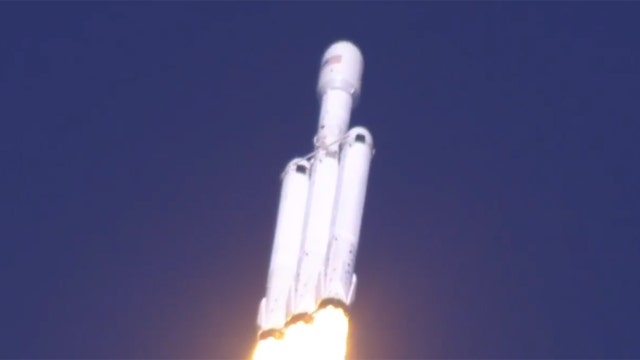 SpaceX's big new rocket blasts off with sports car on top