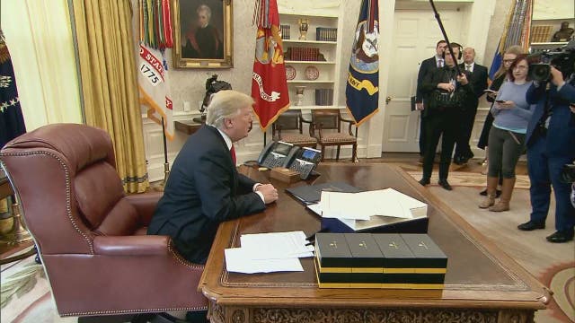 Trump signs $1.5 trillion tax overhaul into law