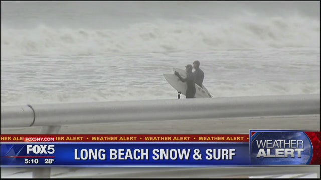 Snow doesn't stop surfers in Long Beach