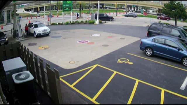 Woman jumps on hood of her car to stop carjacker, who continues to drive