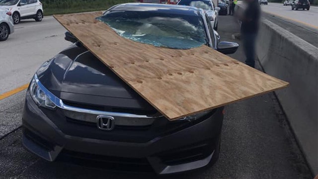 Florida driver uninjured after plywood slices through windshield