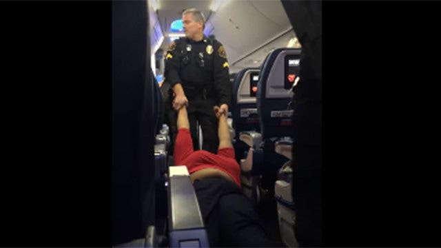Woman dragged along floor off flight