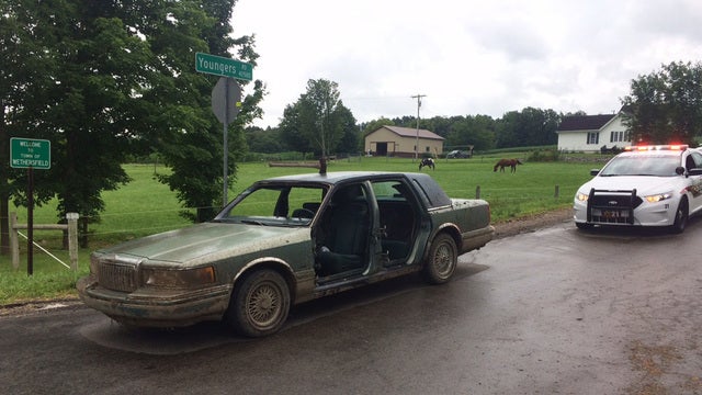 Man arrested after driving with ax in roof