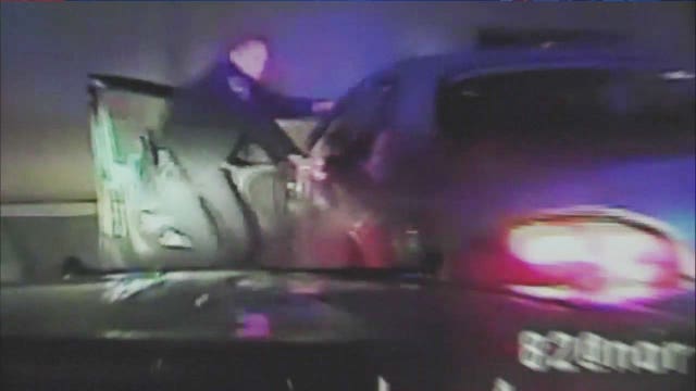 ON CAMERA: Woman strikes cop with car door during traffic stop