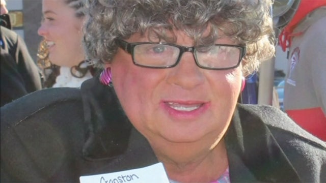 Man dressed as old woman for official's photo op