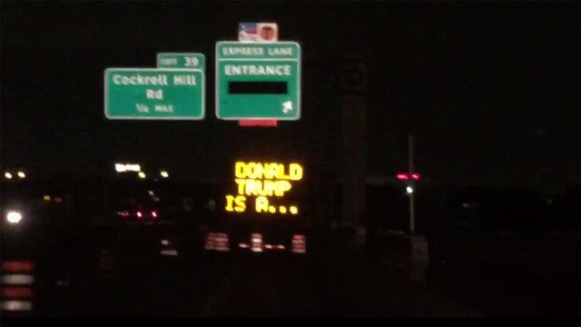 Hacked construction signs call Donald Trump a lizard