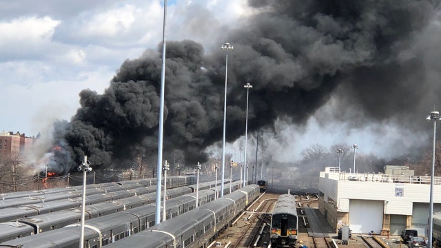 Fire rages near LIRR tracks in Queens