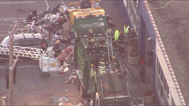 Man gets stuck in trash truck