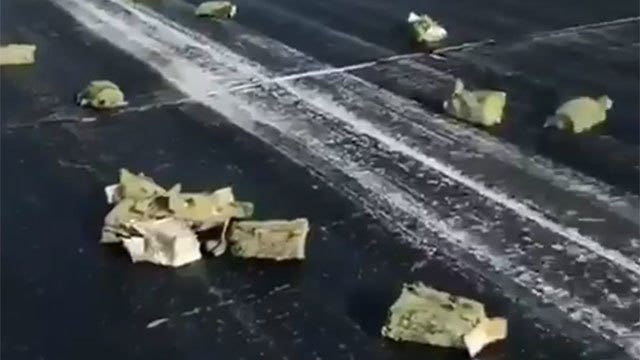 Gold spills on Russian runway after plane door glitch