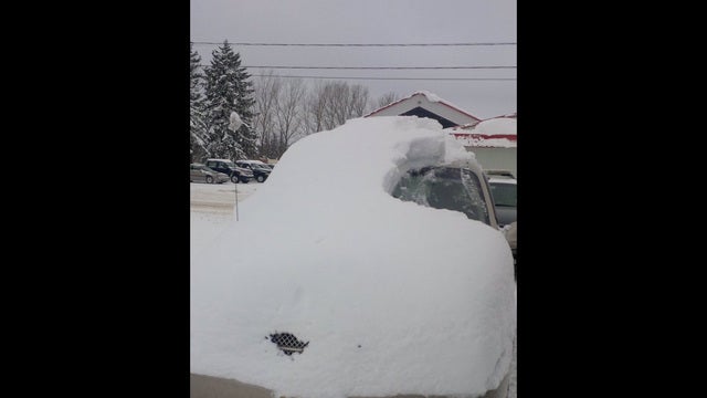Man charged after his car almost completely covered in snow