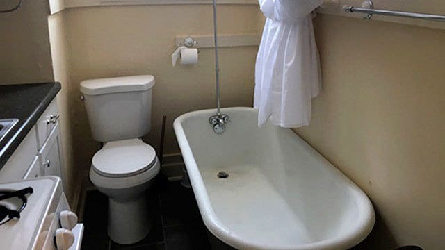 Tiny apartment features toilet next to stove