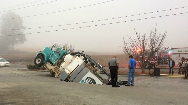 Roads closed after truck gets stuck in sinkhole