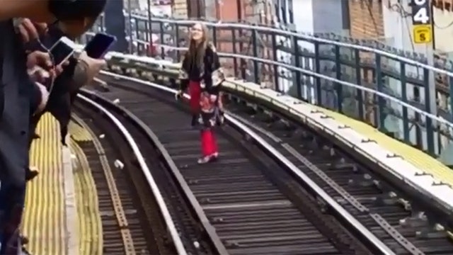VIDEO: Woman walks along subway tracks towards Manhattan