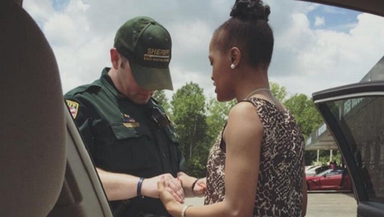 Woman Prays with deputy_1468425342686-401096.jpg