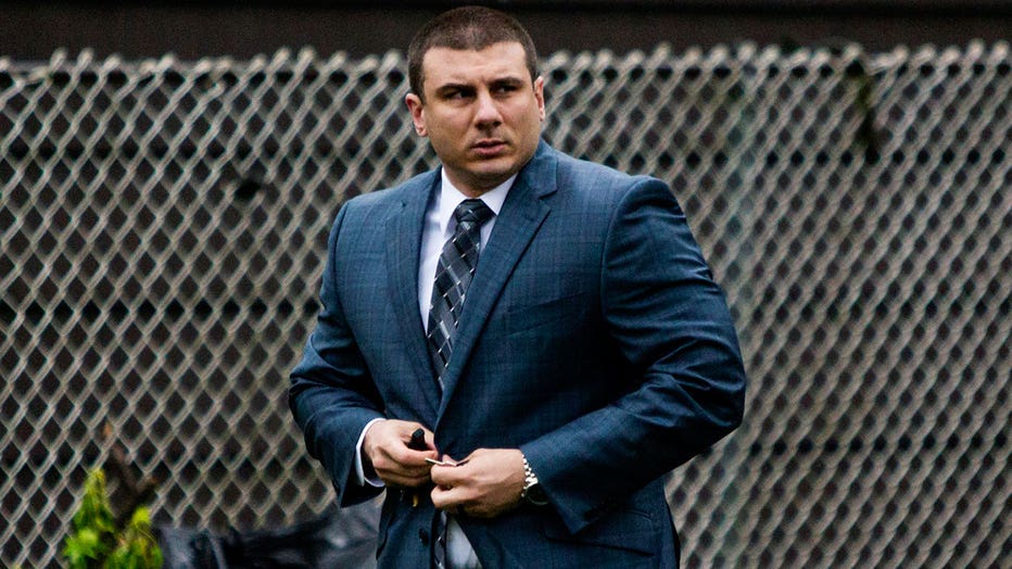 Daniel Pantaleo buttons his jacket