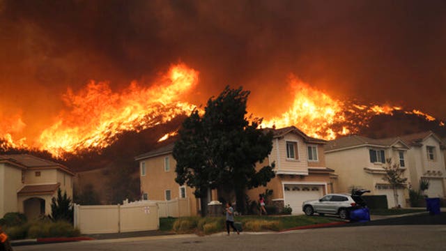 Wind-whipped fires rage across California as lights go dark