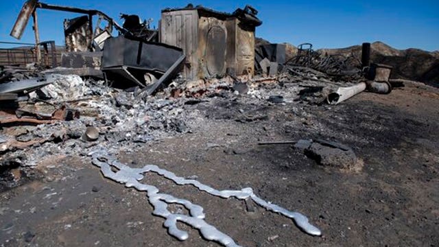 Firefighters race to control blazes before winds roar back