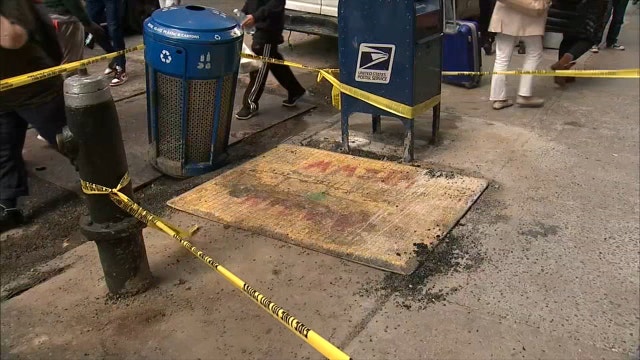 Woman rescued after falling into sidewalk hole in Midtown