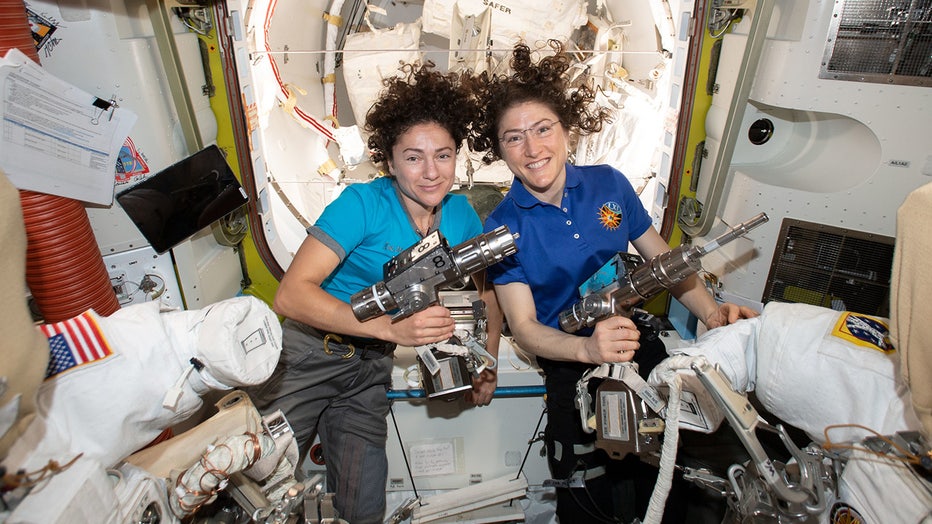 NASA astronauts Jessica Meir (left) and Christina Koch are inside the Quest airlock preparing the U.S. spacesuits and tools they will use on their first spacewalk together.