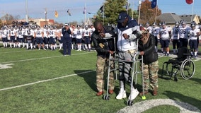 College football player defies the odds to walk on field a year after spinal injury